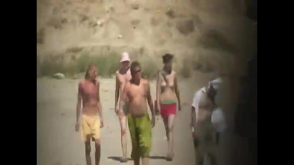 Spying a topless hippie girl on a beach