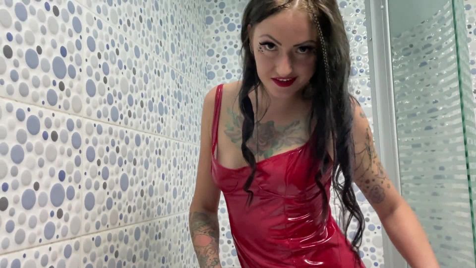 Latex fetish. Dominatrix Nika in a latex dress takes a shower. Watch as the drops of water cover