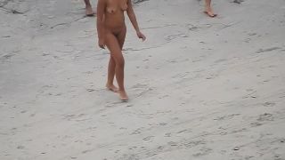 Nude beach, amateur girl shows tits and pussy