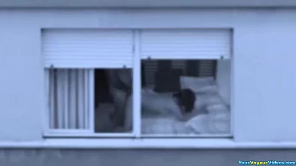 Mature couple fucking by the window