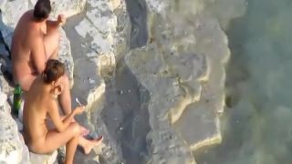 Romantic masturbation on a rocky beach