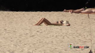 This doll naturist strips bare at a public  plage