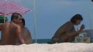 Woman removes her bikini on a beach