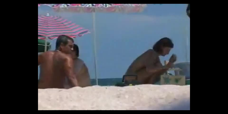 Woman removes her bikini on a beach