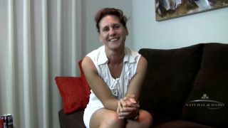 Inge talks on the couch and reveals hairy pussy milf Inge