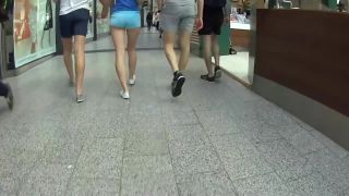 Elegant teen in shorts walks with hipster boyfriend