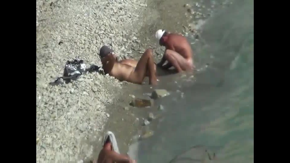 Two couples enjoying sex on a beach
