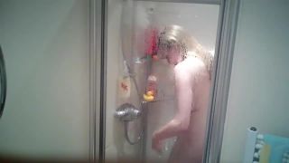 cute busty blonde girl taking a shower and shaving legs. hidden cam