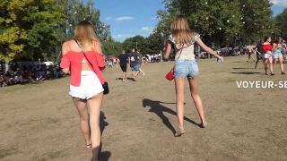 Sexy friends in shorts on a music festival voyeur 