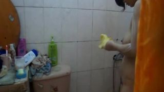 Asian woman showering and drying