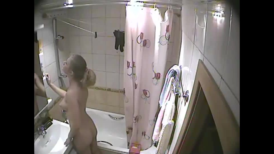 Young blonde girl caught in a  shower