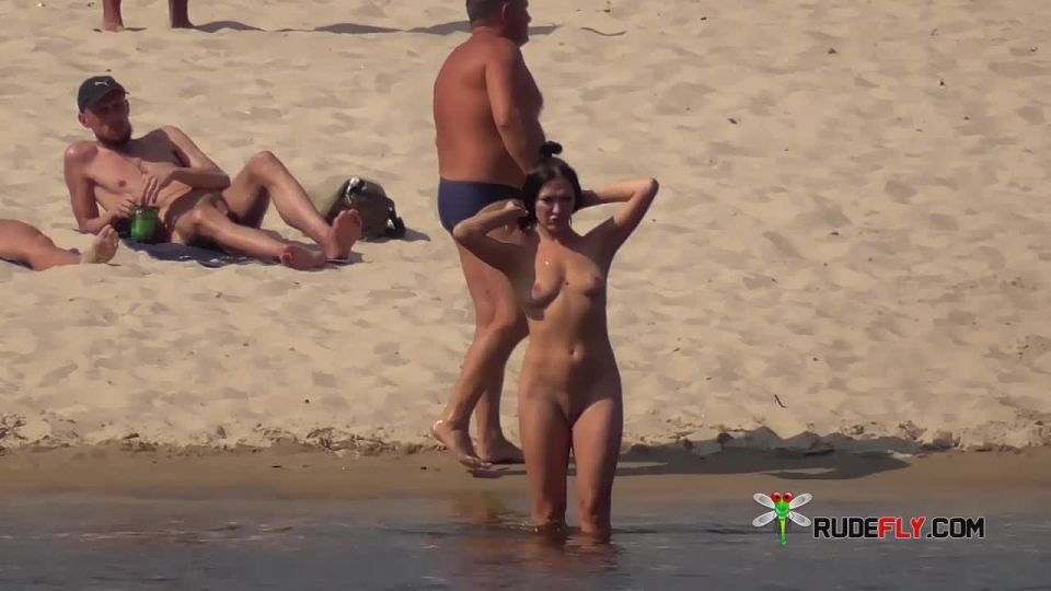 Naked female naturist lets the water kiss her body  3