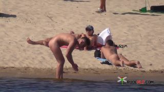 Shy teen pops her top off for all the beach goers  3