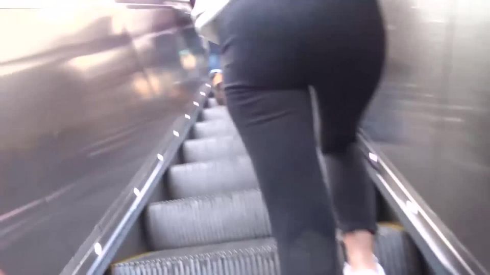 Gorgeous lady on the moving stairs