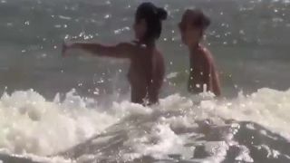 Topless and nude friend at  beach