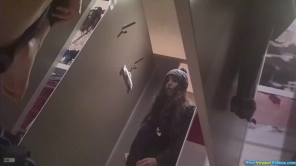 Teen tries pants in dressing  room