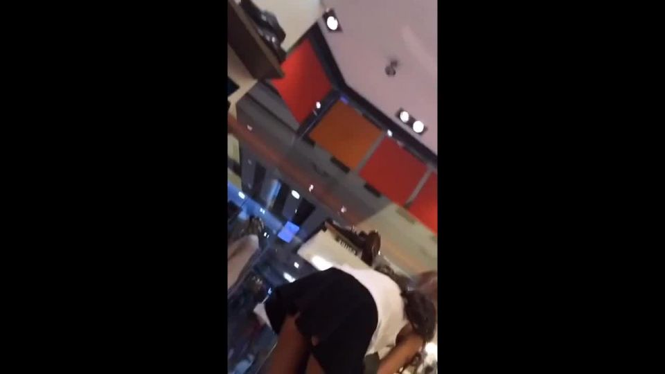 Commando upskirt of bent over girl in shoe store