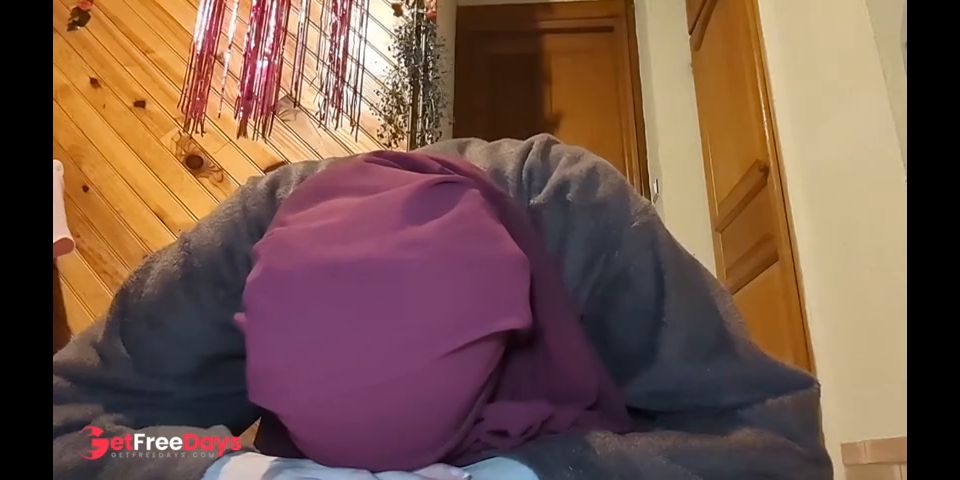 A beautiful veiled Muslim woman goes out in the evening to act naughty
