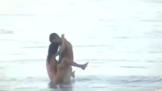 Wild fuck in the water caught by a voyeur Nudism!