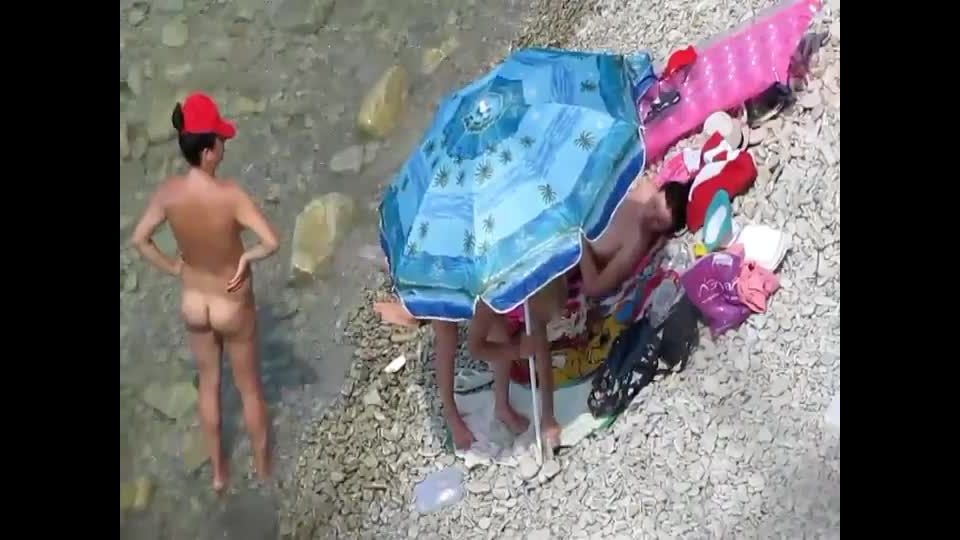 Spying a nudist family on the  beach