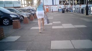 Blond businesswoman in tight white skirt