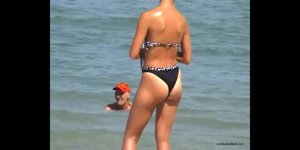 Spy video of a hot brunette on the  beach
