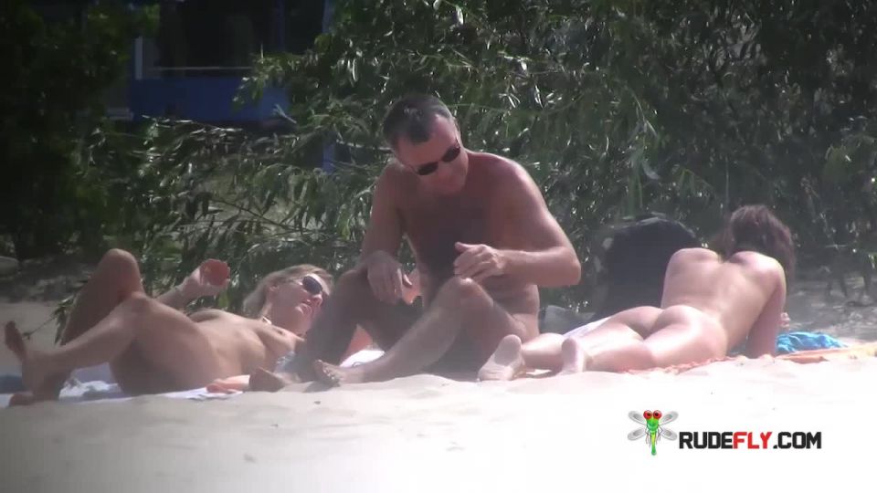 Wet nudist strips down naked at a public beach  2