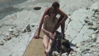 Skinny girl with her man on a beach