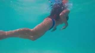 Underwater spying on young mermaid