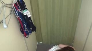 Asian woman takes off all her clothes in change cabin