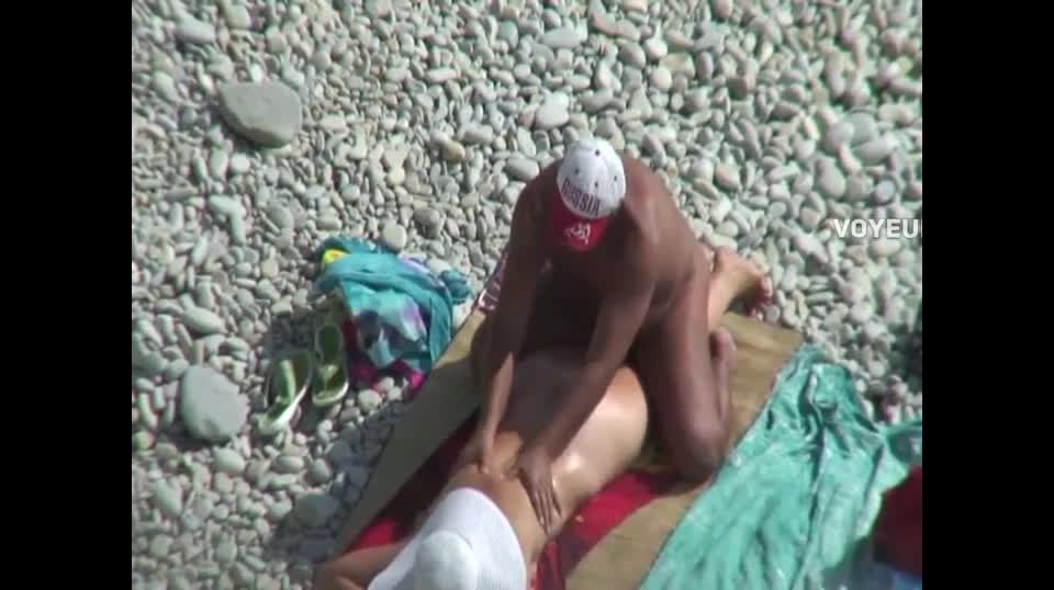 Playful pretend massage on a beach