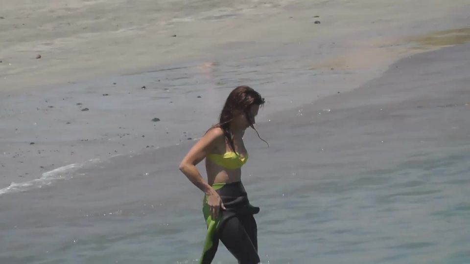 Surf babe gets out of wetsuit