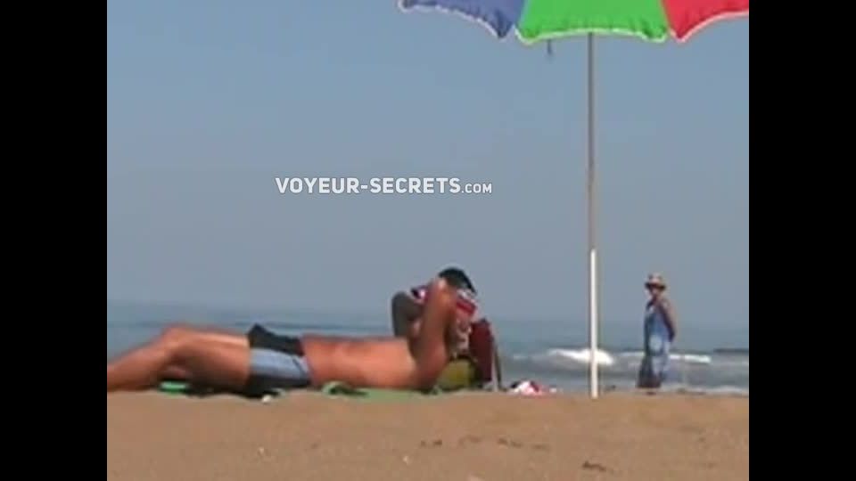 Hot lady gives a handjob at a beach Voyeur!
