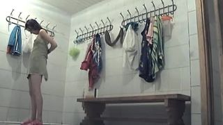 Teens drying and dressing in locker  room