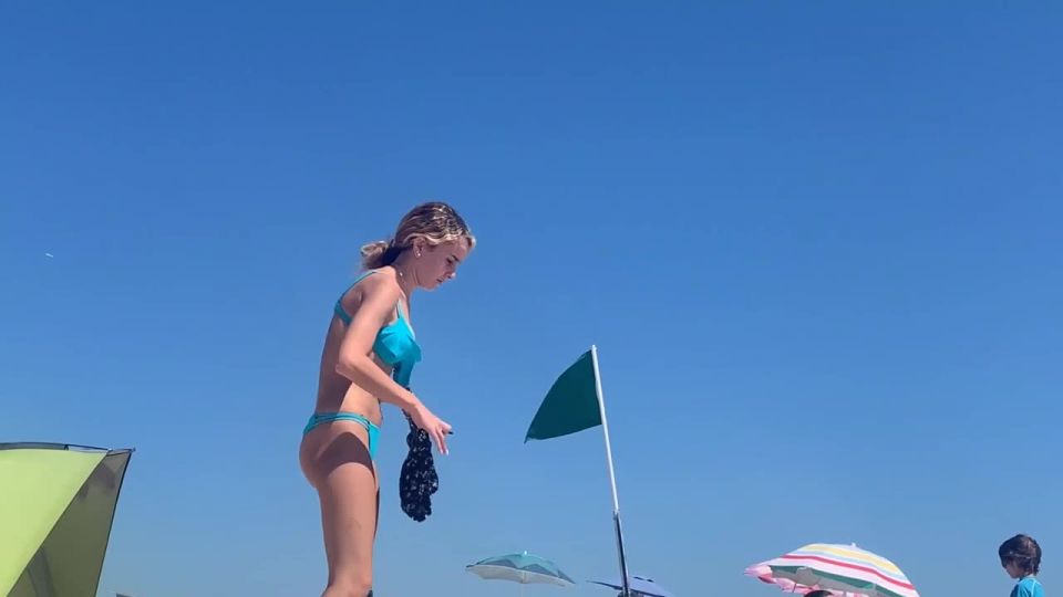 Petite girl in a very sexy pose on the beach