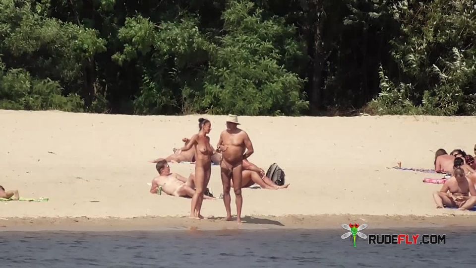 Naked teen naturist lets the water kiss her  body