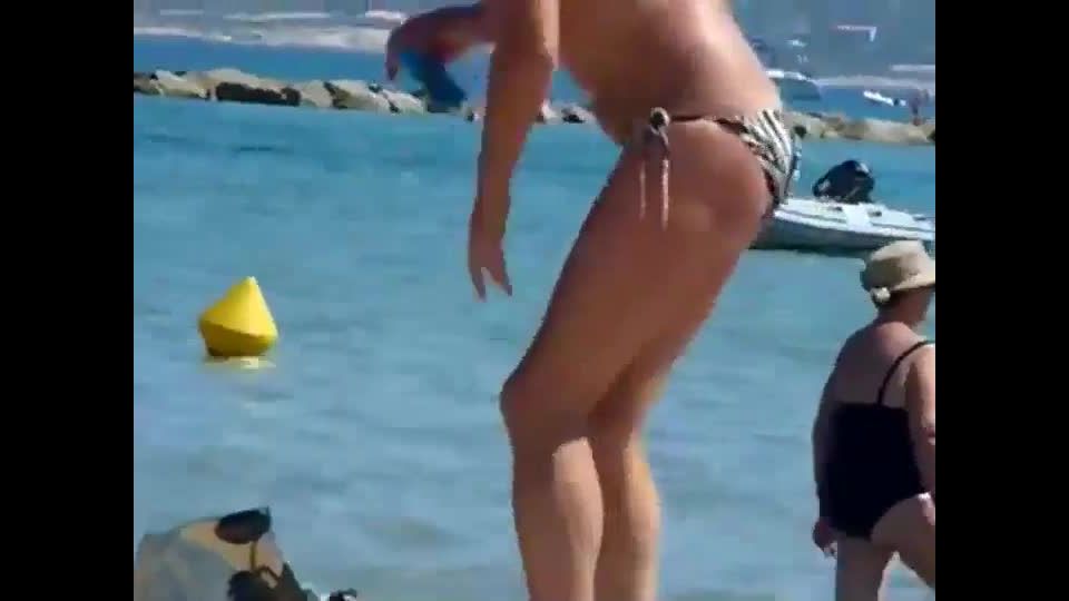 Mature topless woman spied on a beach