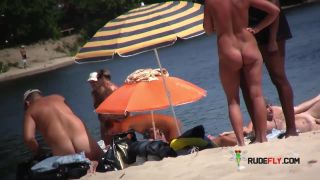 Watch these smooth nudists play at a public beach  3
