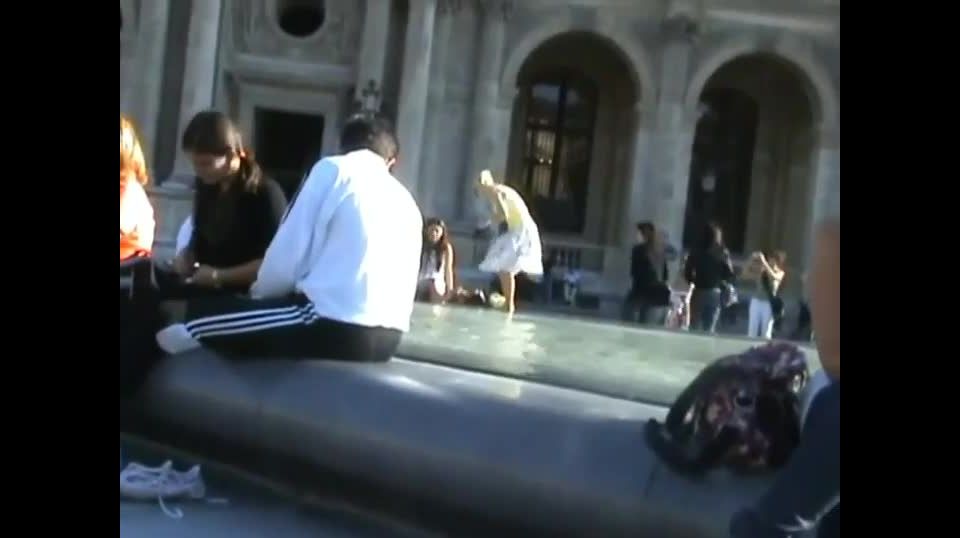 Upskirt of a girl by the fountain